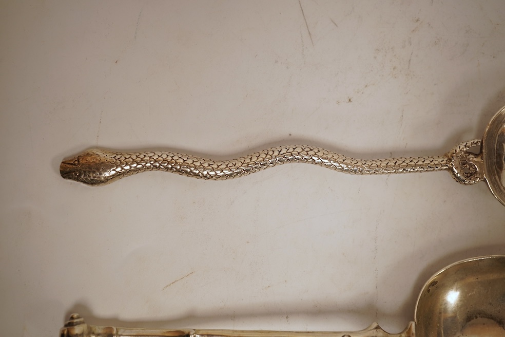 An 18th century silver apostle spoon, indistinct marks, 17cm, a continental white metal spoon with scroll handle and a pair of unmarked white metal spoons with serpent handles.